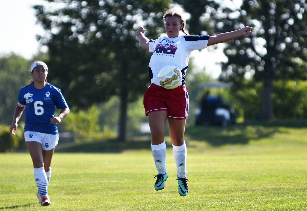 Drew Copeland, 14, jumps to control a high ball